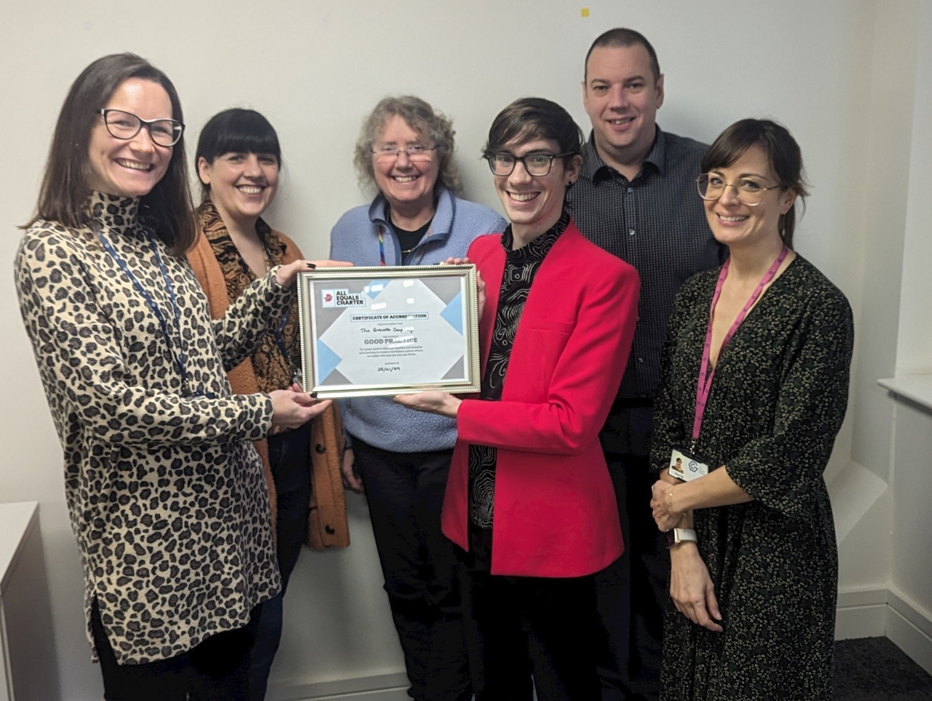GC colleagues receiving All Equals Charter reaccreditation alongside Dr Christopher Owen, Inclusivity Development Manager at Manchester Pride 
