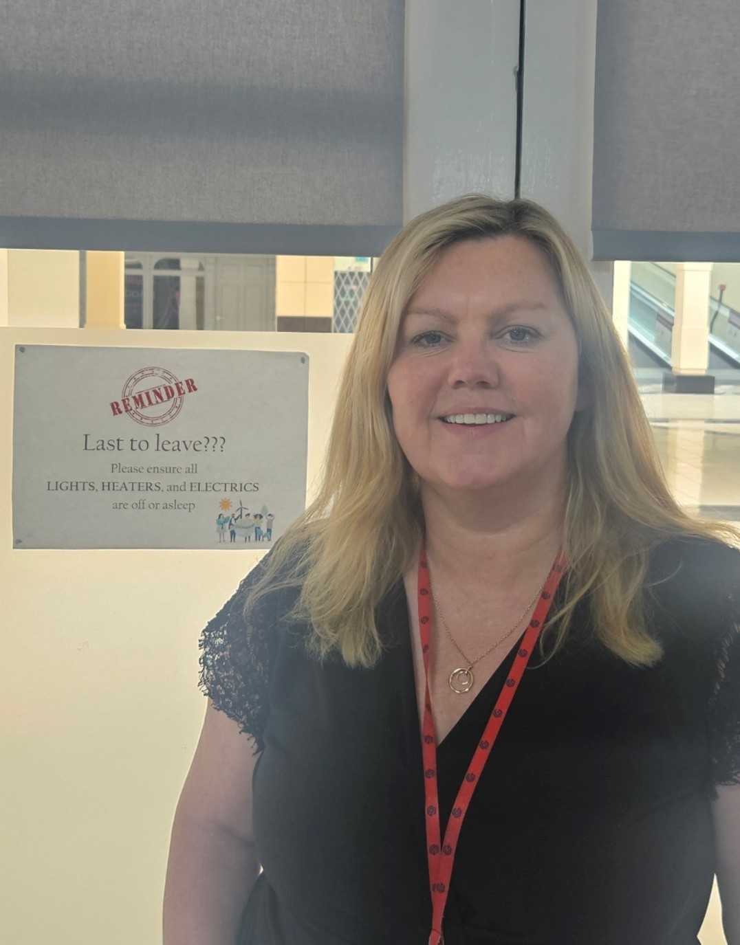 Grace Watson with sign to switch off devices