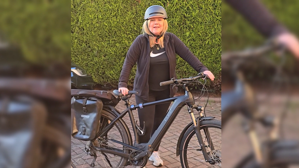 Photo of Grace Watson with the bike she bought through the Cycle to Work scheme