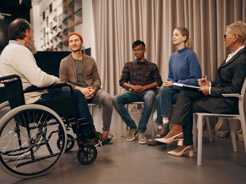 Image of people in the community seated and having a conversation