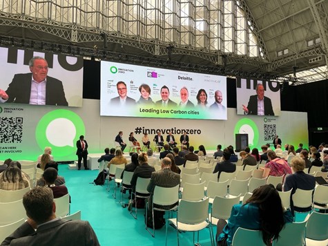 Photo looking towards the stage at the Innovation Zero event including some presenters