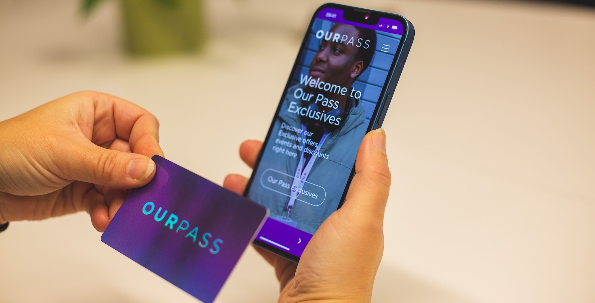 Person using Our Pass Exclusives app on phone