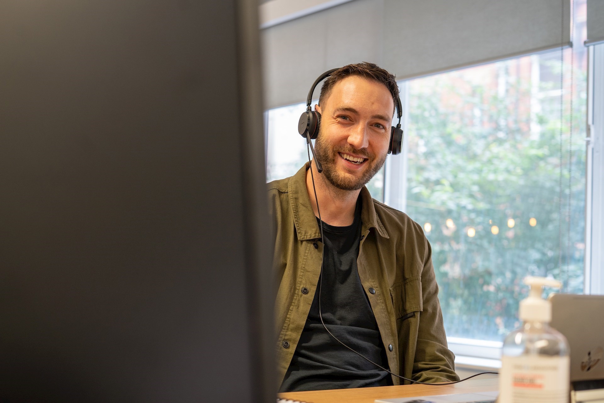 Colleague wearing a headset and smiling