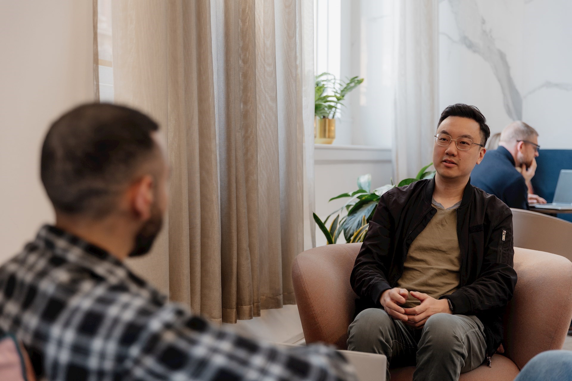 Two colleagues facing each other having a conversation