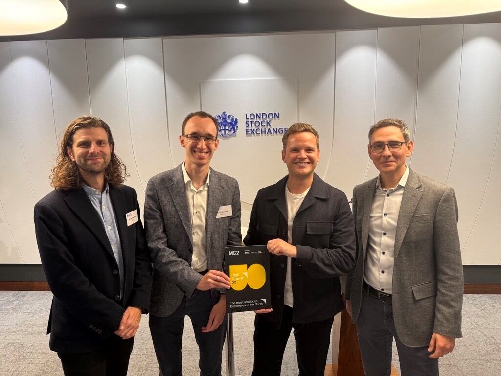 Four people, including Richard Jeffery and Nathan Shoesmith, at the London Stock Exchange holding a copy of the High Growth 50 list