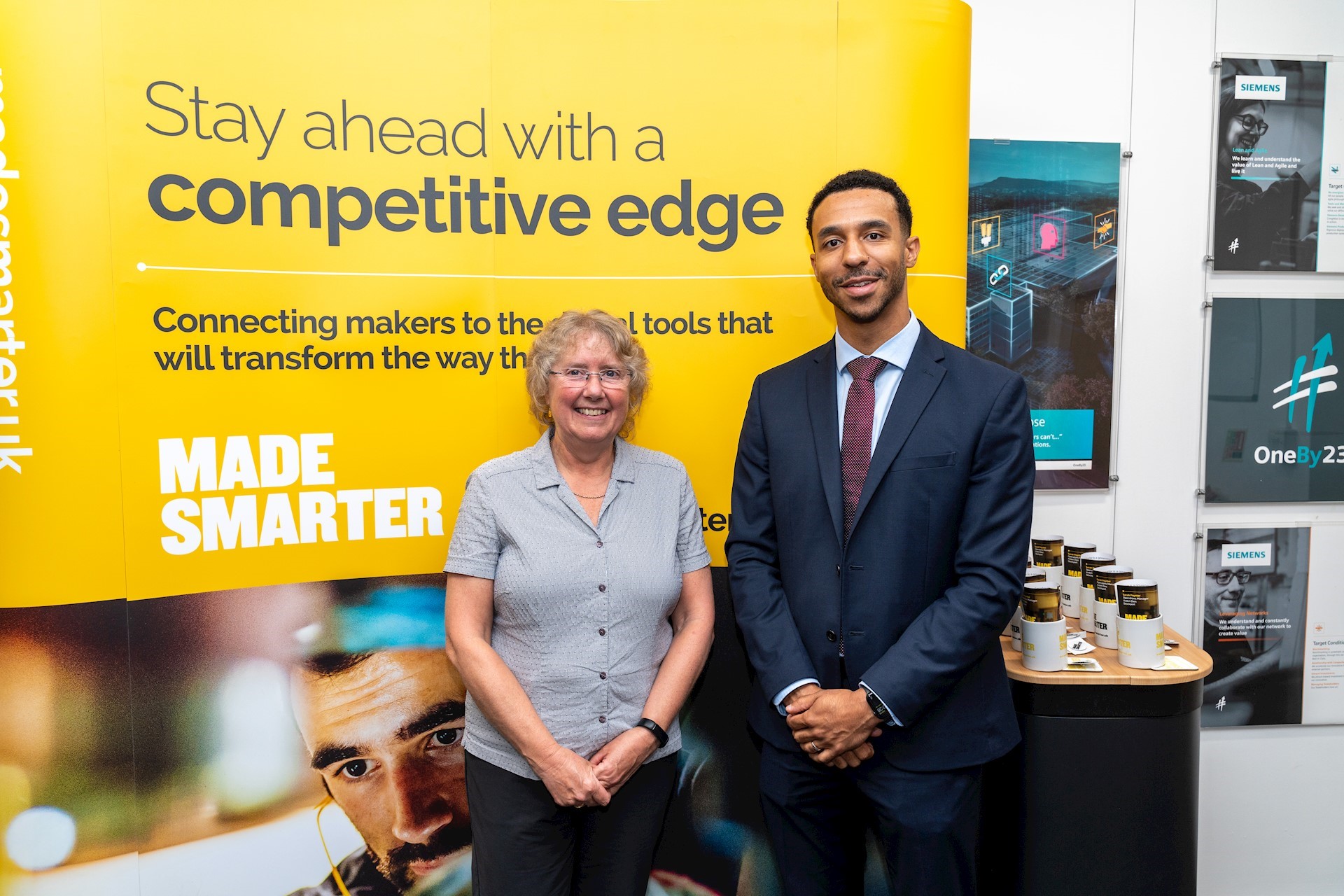 Donna Edwards, Director of Made Smarter’s North West adoption programme, and Paul McLaren, Chair of Made Smarter North West’s Steering Group and Production Director for BAE Systems, stood together next to Made Smarter banner