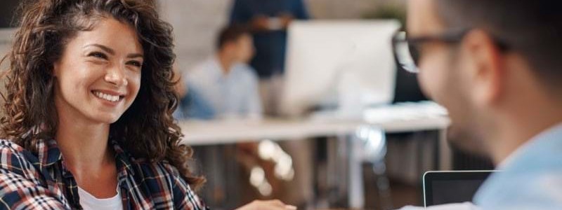 Man and woman shaking hands and smiling Man and woman shaking hands and smiling