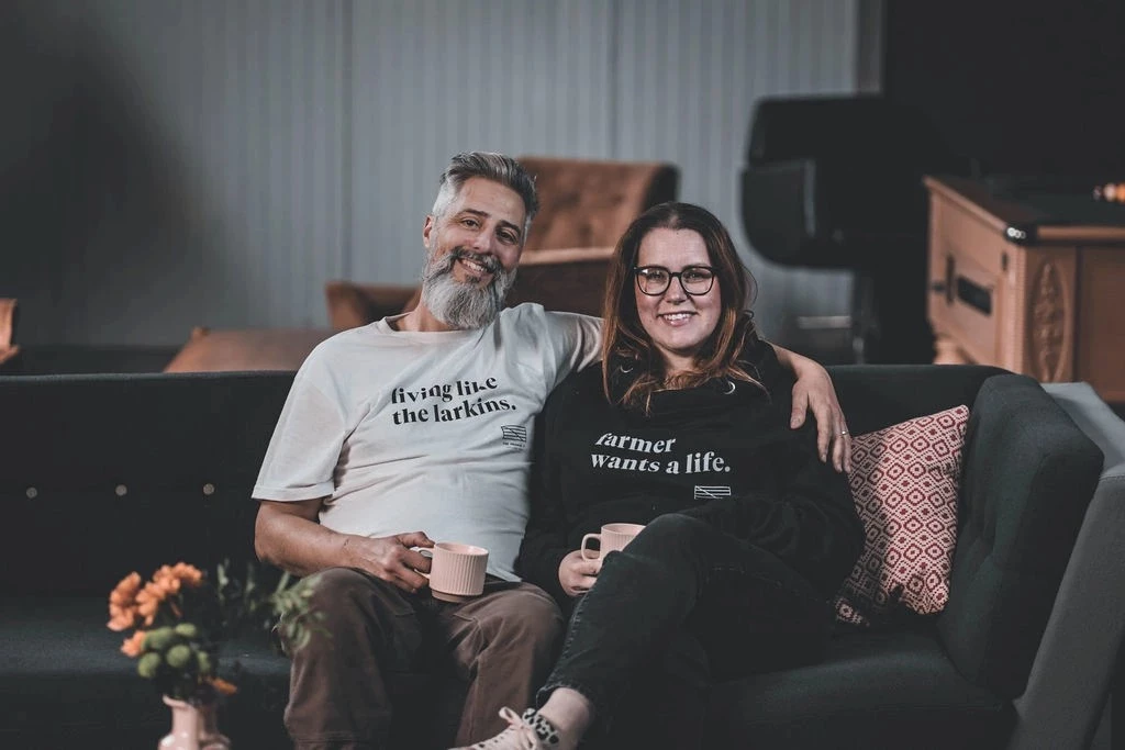 Two clients who have benefitted from Enterprising You support sitting on a sofa together 