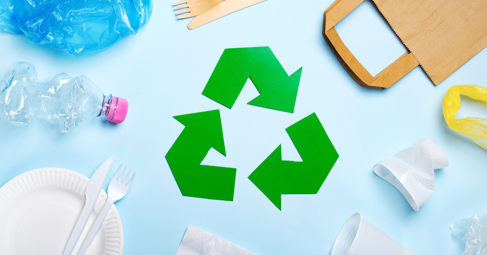 Image of carious items that can and can't be recycled, including a paper bag and plastic bottle, with the green recycling logo in the middle