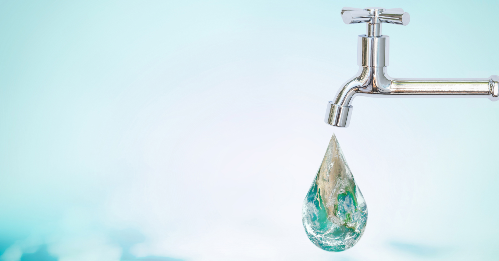 Image of a silver tap with a drop of water pouring out